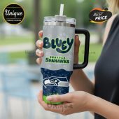 Tumbler shows Seattle Seahawks design with 'Bluey' text, team logo, footballs and paw prints!