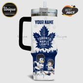 White tumbler featuring a Toronto Maple Leafs logo, custom name option, and cartoon dogs playing hockey.!