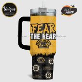 Yellow travel mug with black handle featuring 'Fear the Bear' and Boston Bruins logos and hockey sticks pattern!