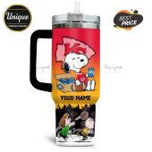 Tumbler featuring Snoopy with a Chiefs logo, football, and beer cans. Charlie Brown and Lucy at the bottom.!