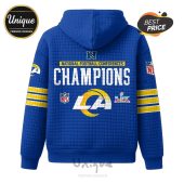 Los Angeles Rams Super Bowl hoodie with team logos, 'Champions' text, and NFL branding on a blue quilted background.!