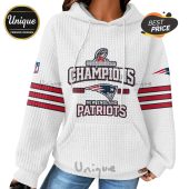 White hoodie with 'Champions' and 'New England Patriots' text with the team logo and red and blue stripes on sleeves.!