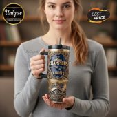 New England Patriots Champions 2025 and 2056 printed on a tall black & gold travel mug with handle and straw.!