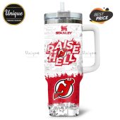 Stanley tumbler features Peanuts comic and New Jersey Devils logo with 'Raise Hell' text.!