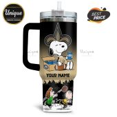 Tumbler featuring Snoopy, Charlie Brown, Lucy, Bud Light, and the New Orleans Saints logo with custom name option.!