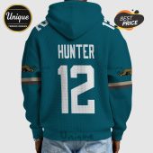 Back of hoodie with 'Hunter' and '12' in white font. Teal jacket with Jaguars logo on sleeves.!