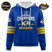 Blue hoodie with 'Champions' and 'Rams' text, NFL logo, years 2025 and 2026, team colors.!