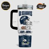 Tumbler features Snoopy in Seahawks gear with 'Go Seahawks' and 'Est. 1974' text.!