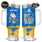 Stanley tumbler featuring Snoopy playing hockey, the St. Louis Blues logo, and the text 'We Bleed Blue'.!
