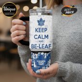 White travel mug with 'Keep Calm and Be-Leaf' and Toronto Maple Leafs design.!