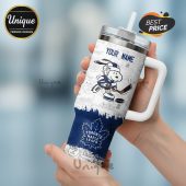 Customizable travel mug featuring Snoopy playing hockey with Toronto Maple Leafs logo and comic strip background.!