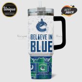 Vancouver Canucks travel mug with team logos, hockey sticks, snowflakes, goalie masks, and the text 'Believe in Blue'.!