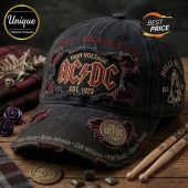 Distressed black AC/DC baseball cap with red/gold 'HIGH VOLTAGE AC/DC EST. 1973' logo, 'BACK IN BLACK' text, 'HELLS BELLS' patch, band members' names!