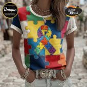 Multicolored puzzle piece tee with a rainbow autism awareness ribbon graphic, patchwork style stitching details, white collar and sleeve cuffs!