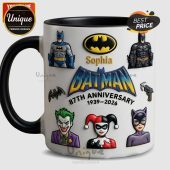 White mug: Batman 87th Anniversary 1939-2026. Features Sophia, Joker, Harley Quinn, Catwoman characters!