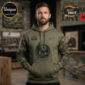 Green hoodie w/ camo sleeves, bird graphic, 'Collingwood 1892' text! Nike swoosh, Lest We Forget graphic on sleeve!