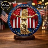 Golden Dolly Parton statue on blue ring with white stars, red white striped background, and text '250 YEARS OF CELEBRATION DOLLY PARTON'!