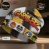 Gorillaz beanie with patchwork design, featuring character faces and the band's name.!