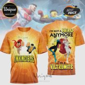 Orange gradient all-over print tee featuring Invincible and Omni-Man comic art! Text reads INVINCIBLE front, I'M NOT A HERO ANYMORE I'M A VILTRUMITE back!