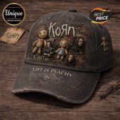 Distressed black Korn band hat, nu-metal grunge art with voodoo dolls. Text: KORN, LIFE IS PEACHY!