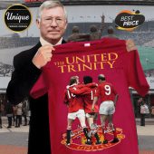 Red retro football tee with 'THE UNITED TRINITY' text, featuring George Best, Denis Law, Bobby Charlton and autographs!