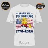White tee: Pikachu on a Poke Ball with a US flag background. Text: SPARK OF FREEDOM, 1776-2026. Red, white, blue, yellow colors!