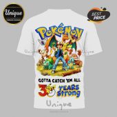 White tee with Pokemon, Ash, Pikachu, Bulbasaur, Charmander, Squirtle. Text: Gotta Catch 'Em All, 30 Years Strong!
