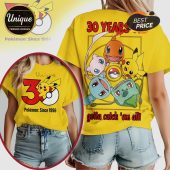 Yellow tee: '30 Years Pokemon: Since 1996'. Features Pikachu, Charmander, Mew, Squirtle, Bulbasaur. 'Gotta catch 'em all!'!