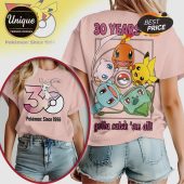 Pink tee featuring Pokémon like Pikachu, Charmander, Bulbasaur, Squirtle, and Mew with text '30 Years' and 'Gotta Catch 'em all'!