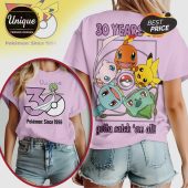 Lavender tee with cartoon design. Text: 30 YEARS, gotta catch 'em all, Pokemon since 1996.!