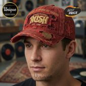 Distressed red Rush band cap! Gold embroidered Rush logo, 'EST. 1968', 'Moving Pictures', 'A Show of Hands' text! Starman emblem! Features Alex Lifeson, Geddy Lee, Neil Peart!