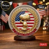 Novelty coin: Gold Snoopy salutes! Red/white stripes, blue stars. Text: '250 Years. One Nation.' Patriotic vibe!