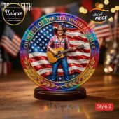 Glittery patriotic plaque featuring a cowboy playing guitar in front of an American flag, with 'COURTESY OF THE RED, WHITE AND BLUE' text!