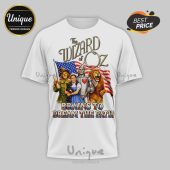 White tee with The Wizard of Oz, stars and stripes flag, and 'Brains to Dream the Path' text!
