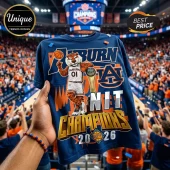 Blue Auburn Tigers basketball shirt with mascot graphic! Text reads 'Auburn NIT Champions 2026' in orange and gold letters!