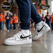 Custom white sneakers with a black swoosh, Auburn Tigers logos, and text 'War Eagle' and 'NIT '24 Champions' in orange and blue!
