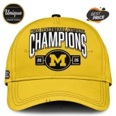 Yellow cap with 'NCAA Basketball National Champions' text, black and yellow 'M' logo, and 2026 year! Athletic sports style!