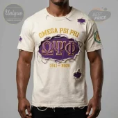 Distressed cream t-shirt featuring gold 'OMEGA PSI PHI' text, purple 'ΩΨΦ' Greek letters, and '1911-2026' dates!