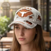 Distressed gray cap features white longhorn logo, orange TEXAS and LONGHORNS text, and orange underlay!