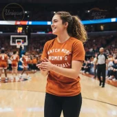 Wear this burnt orange t-shirt featuring bold white text 'WATCH MORE WOMEN'S BASKETBALL' at a court event!