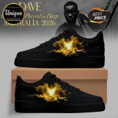 Black sneakers with gold cloud wing graphic design on side panel sitting on cardboard shoe box!