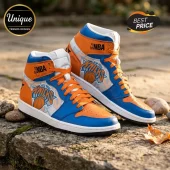 High-top basketball sneakers in blue and orange with New York Knicks logo and NBA branding on a stone surface!