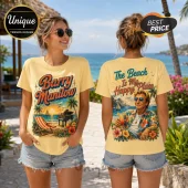 Woman wearing yellow cotton t-shirt with Barry Manilow graphic, tropical beach scene, grand piano, and sunset print.!