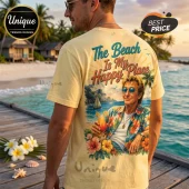 Man wearing a pale yellow t-shirt with a tropical graphic featuring a man in a floral shirt holding a cocktail at beach.!