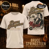 Cream-colored t-shirt featuring Bruce Springsteen graphic with vintage typography and musical motifs.!