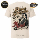 Beige cotton t-shirt featuring a vintage-style illustration of Bruce Springsteen singing with the text On My Mind.!