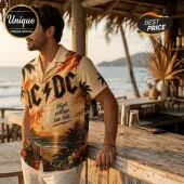Man wearing a cream button-down shirt featuring AC/DC logo, tropical sunset, palm trees, and electric guitar print.!
