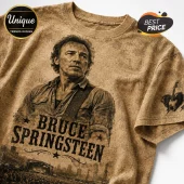 Bruce Springsteen graphic t-shirt in sepia tone with concert crowd print, star accents, and guitar heart sleeve detail.!