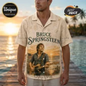 Man wearing tan button-down shirt featuring a Bruce Springsteen print with an American flag and guitar on a beach background.!