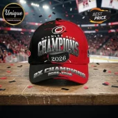 Carolina Hurricanes 2026 Stanley Cup Champions baseball cap with red and black split design and hockey puck graphic.!